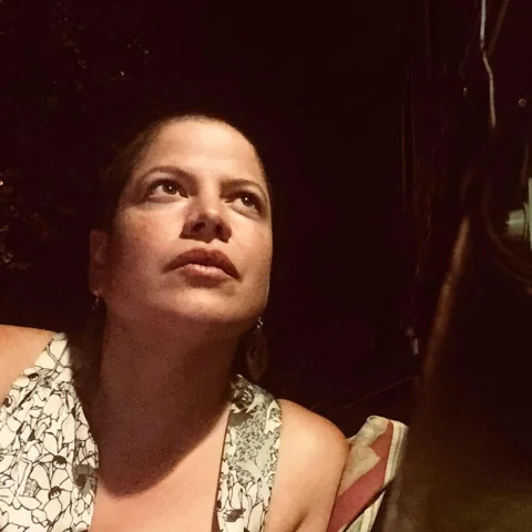 Warmly lit portrait of Geña from the duo’s official website