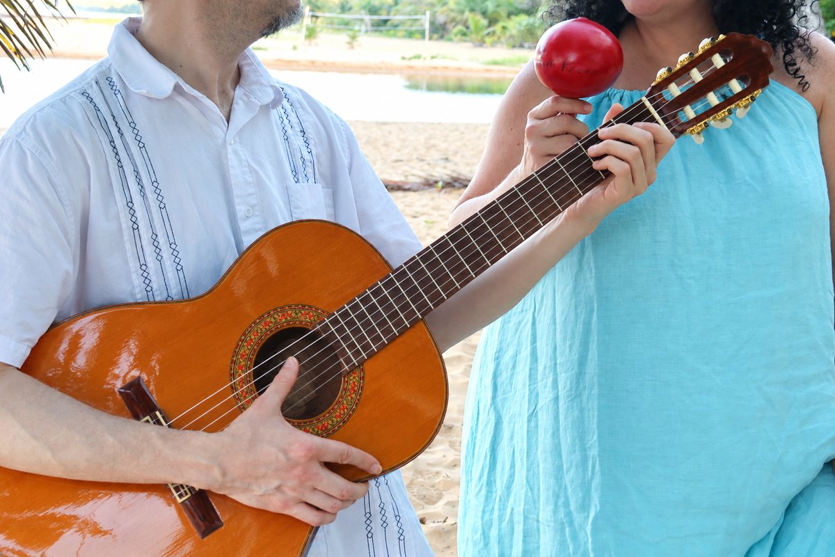 Close view of guitar strings, playing hands and percussion